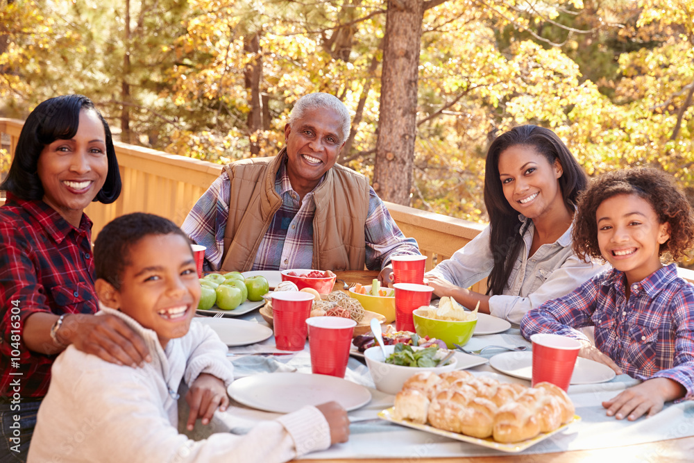 Grandparents With Children Enjoying Outdoor Meal
