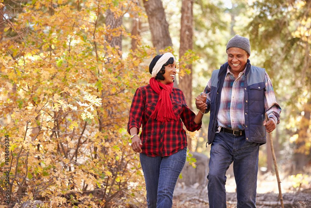 Senior African American Couple Walking Through Fall Woodland Senior African American Couple Walking Through Fall Woodland