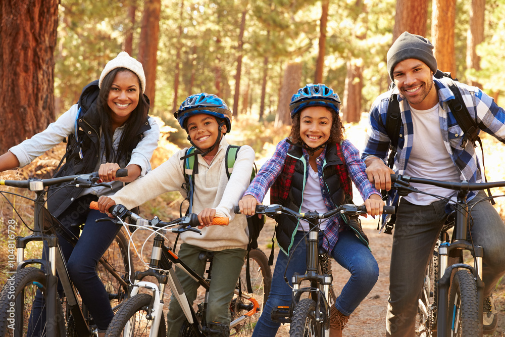 Fototapeta premium Portrait Of Family Cycling Through Fall Woodland