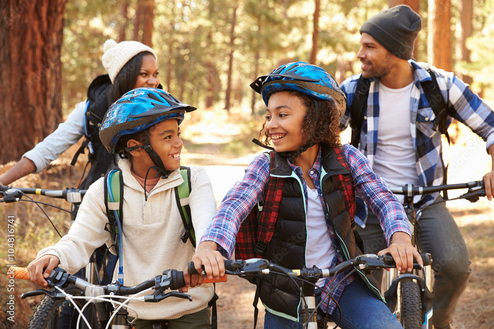 Obraz premium African American Family Cycling Through Fall Woodland