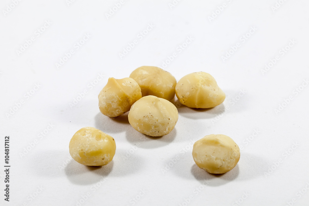 Peeled Macadamia nut on a white background