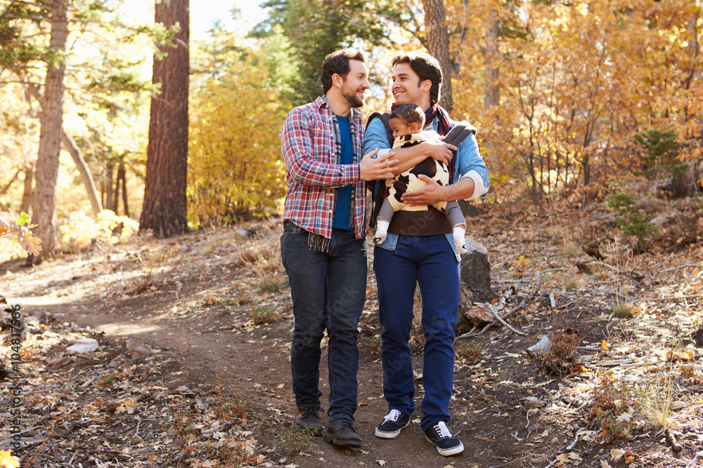Gay Male Couple With Baby Walking Through Fall Woodland Gay Male Couple With Baby Walking Through Fall Woodland