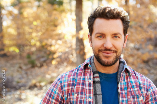 Head And Shoulders Portrait Of Man In Autumn Woodland