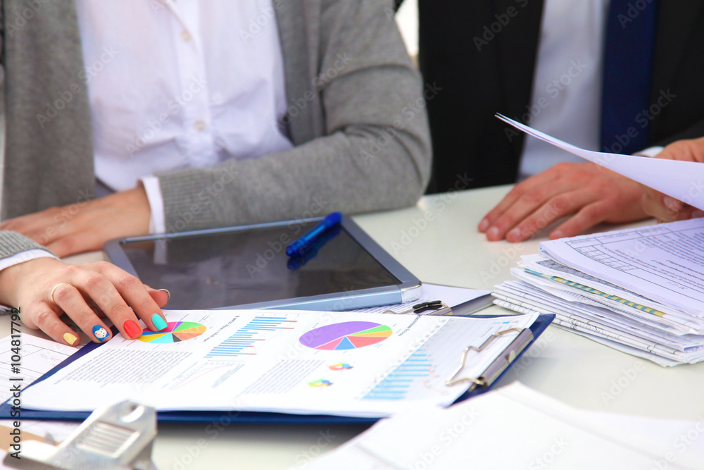 Image of business partners discussing documents and ideas at meeting Image of business partners discussing documents and ideas at meeting