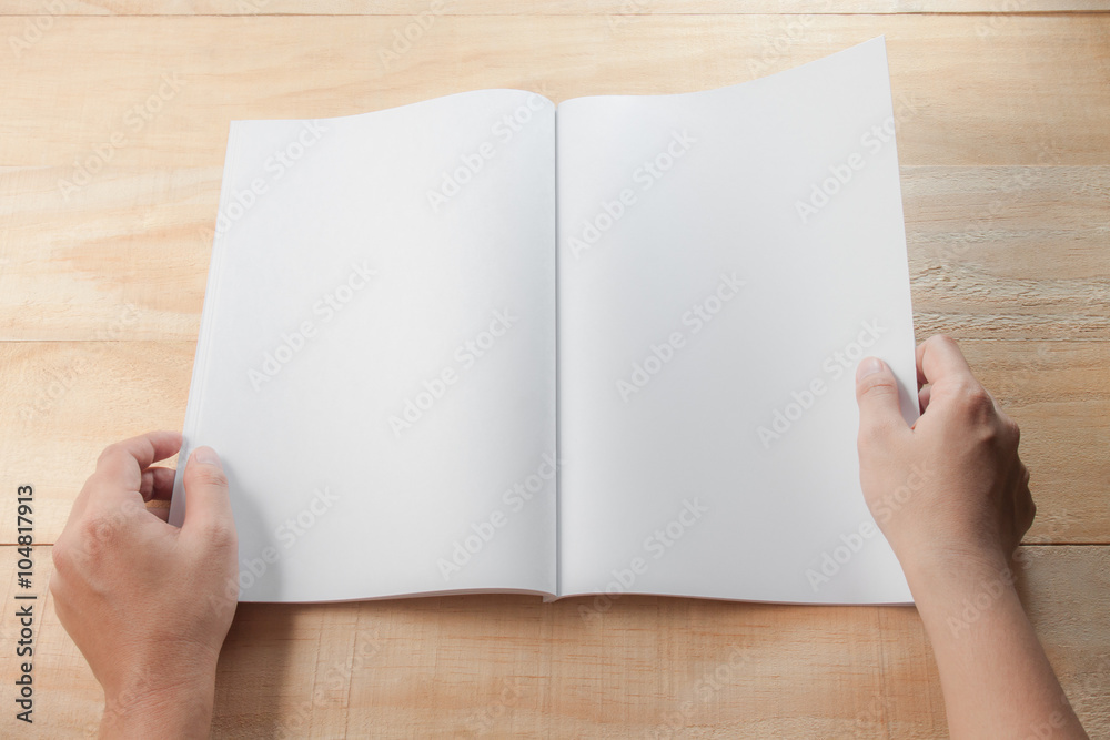 hand open blank. book or magazines, .book mock up on wood backgr hand open blank. book or magazines, .book mock up on wood backgr