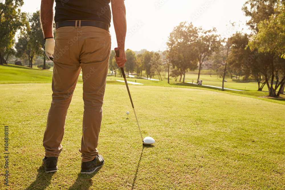 Fototapeta premium Close Up Of Male Golfer Lining Up Tee Shot On Golf Course