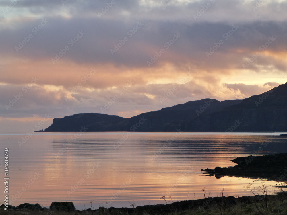 Sunset over Loch Bracadale, Isle of Skye, Scotland, with silhouetted headland