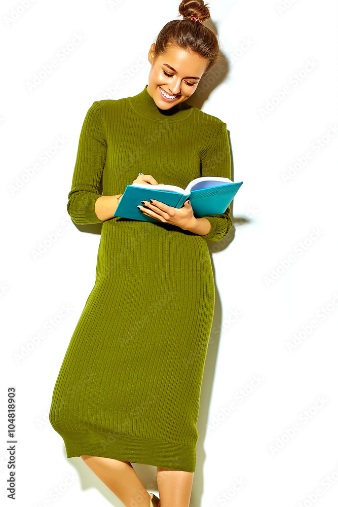 portrait of beautiful happy cute smiling brunette girl student in casual green hipster summer clothes with no makeup isolated on white writing in blue colorful notebook, thinking while studying portrait of beautiful happy cute smiling brunette girl student in casual green hipster summer clothes with no makeup isolated on white writing in blue colorful notebook, thinking while studying