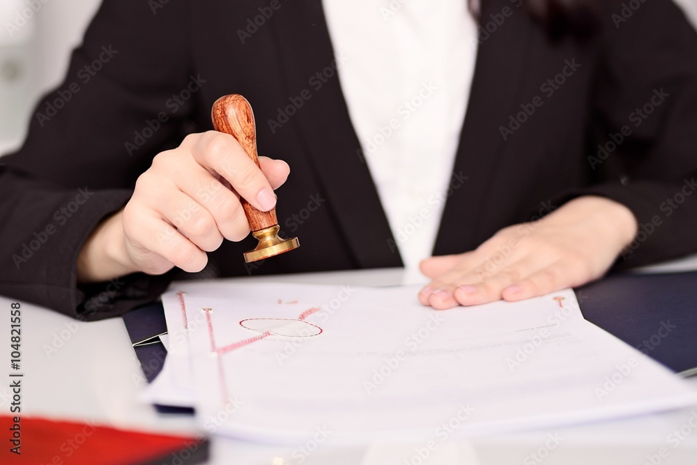 Notary Public woman hands stamping notary act .