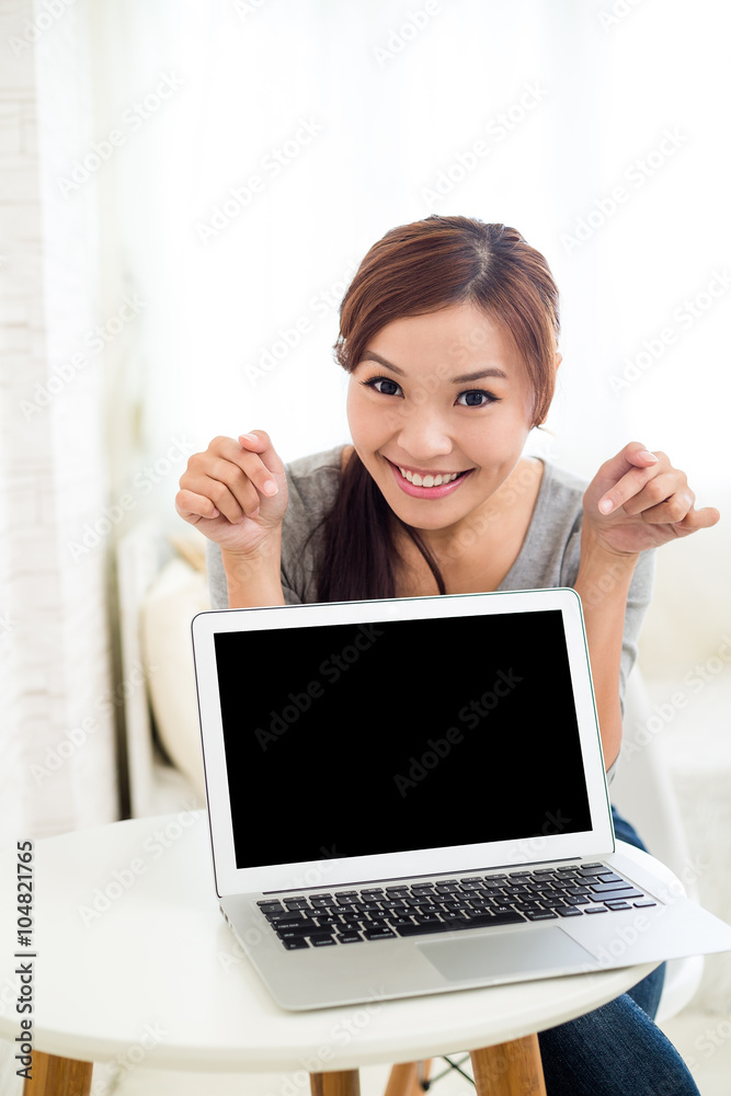 Woman showing blank screen of laptop computer