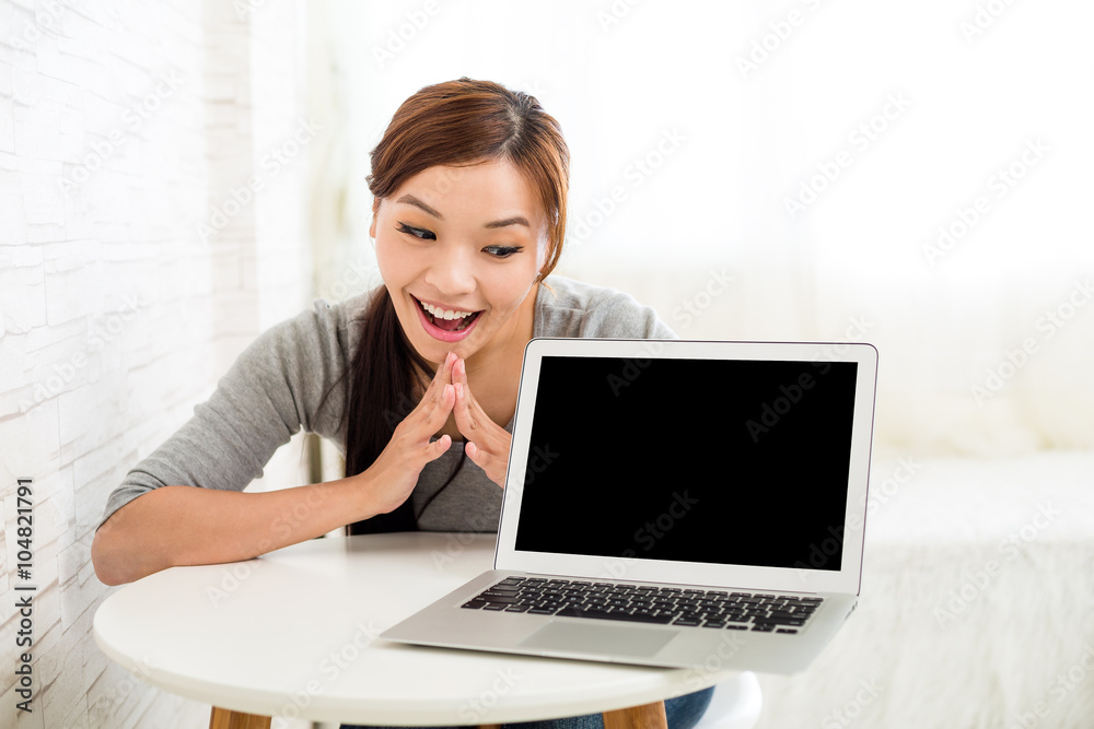 Woman showing blank screen of notebook computer Woman showing blank screen of notebook computer