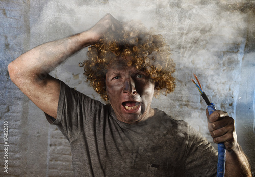 Fotografie man with cable smoking after domestic accident with dirty burnt face shock elect