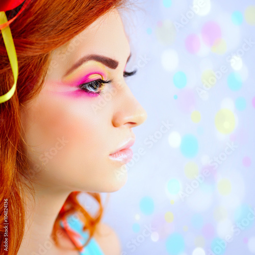 Beautiful red-hair girl with creative makeup in profile