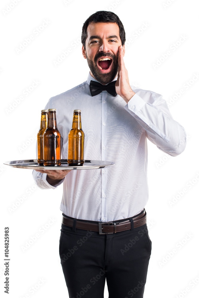 Waiter with beer bottles on the tray doing surprise gesture Waiter with beer bottles on the tray doing surprise gesture