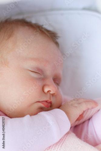 Newborn baby girl sleeping/Cute newborn baby girl sleeping in a cradle