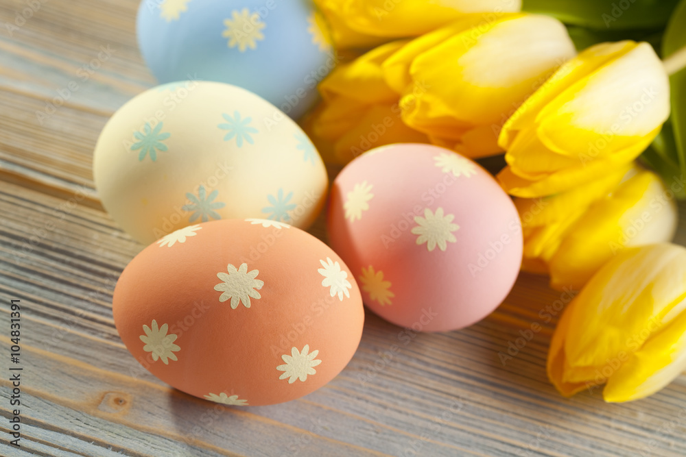 Four Easter eggs and flowers