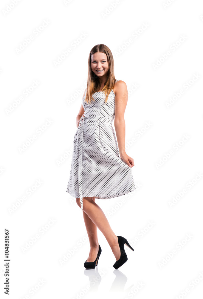 Girl in black-and-white dotted dress, heels, studio shot, isolat Girl in black-and-white dotted dress, heels, studio shot, isolat