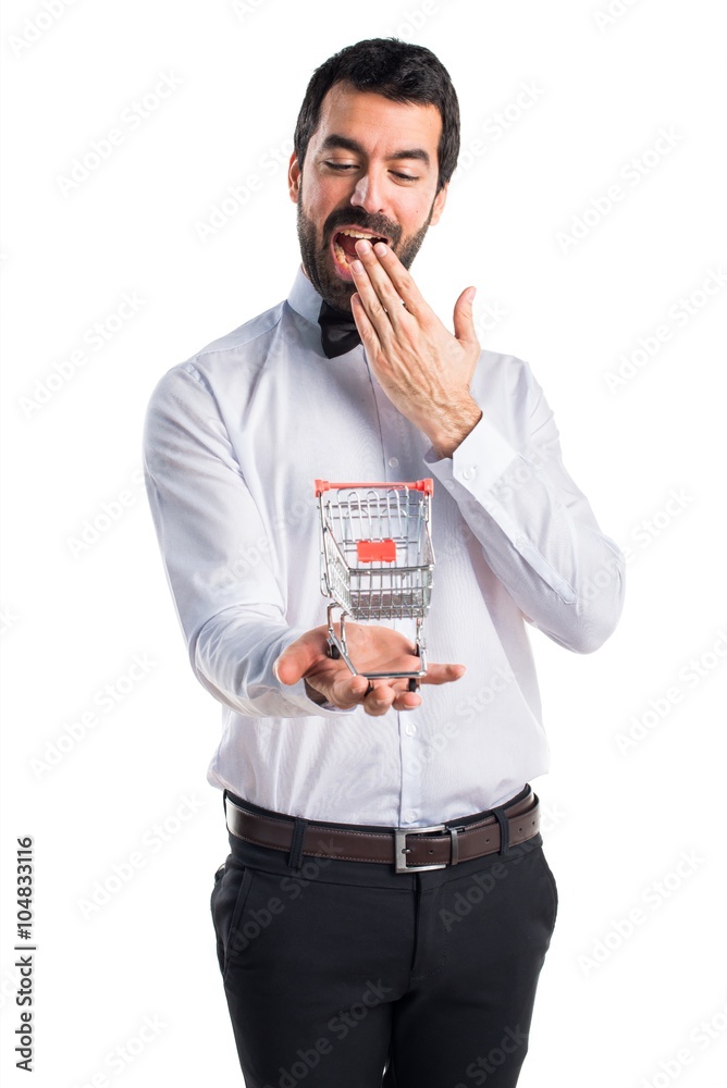 Waiter with beer bottles on the tray holding a supermarket cart Waiter with beer bottles on the tray holding a supermarket cart