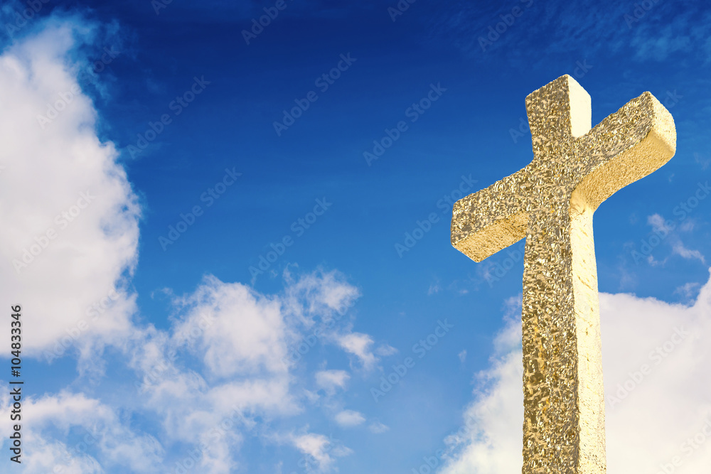 gold cross with blue sky background