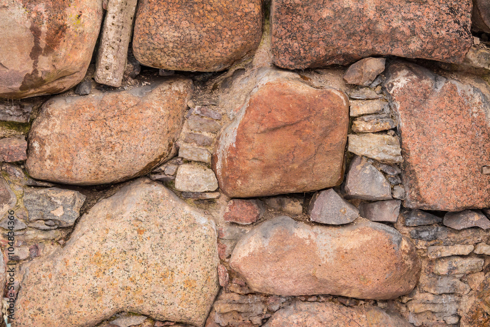 Texture of the relief stone wall closeup.