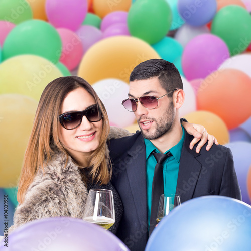 Couple in balloons celebrating 