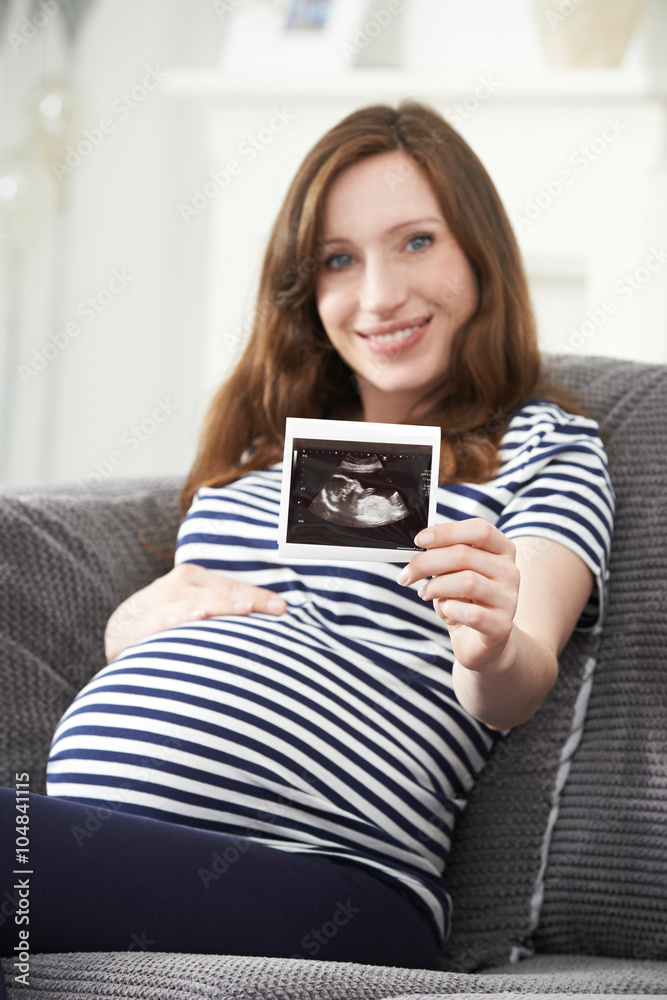 Portrait Of Pregnant Woman Holding Ultrasound Scan Of Baby Portrait Of Pregnant Woman Holding Ultrasound Scan Of Baby
