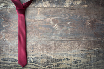 Red tie on wood
