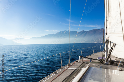 Sailboat navigates in the lake, empty water