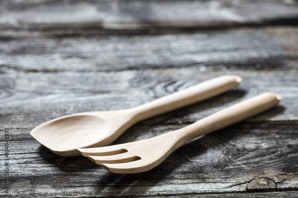 cooking still life - new wooden fork and spoon on genuine wooden background for home-made salad, studio shot cooking still life - new wooden fork and spoon on genuine wooden background for home-made salad, studio shot