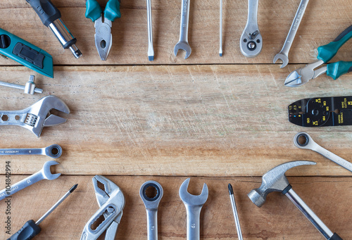 Many tools on old wooden panel