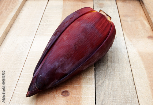 Closed up banana flower put on wooden texture