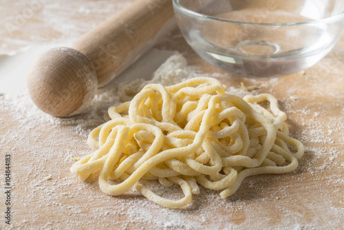 Obraz na płótnie raw egg pasta with flour and rolling pin
