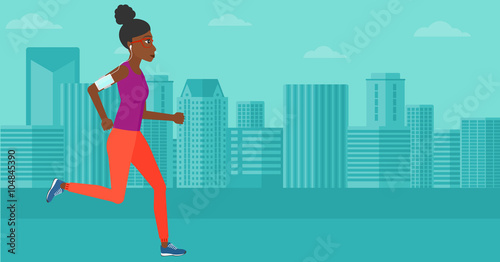 Woman jogging with earphones and smartphone. © Visual Generation