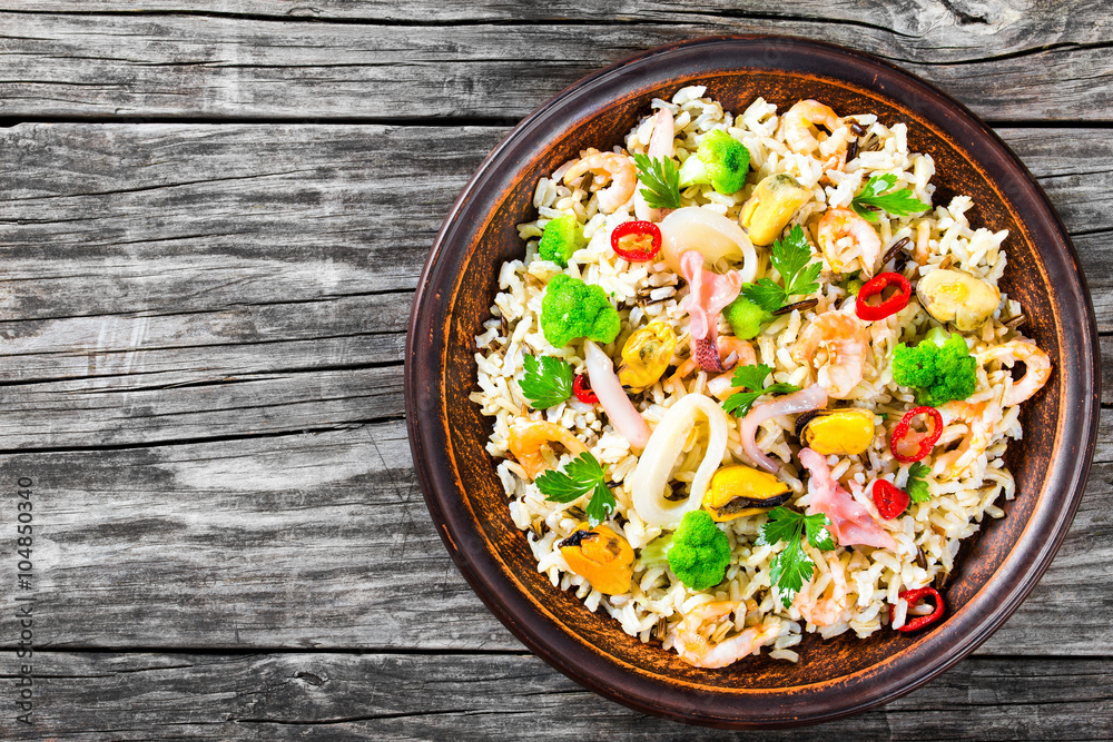 rice with seafood and broccoli in a bowl, top view rice with seafood and broccoli in a bowl, top view