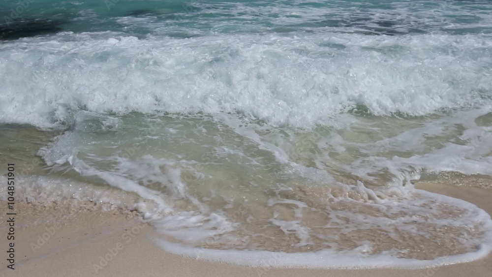 Surfing sea waves with foam on white tropical sandy beach
Surfing sea waves with foam on white tropical sandy beach