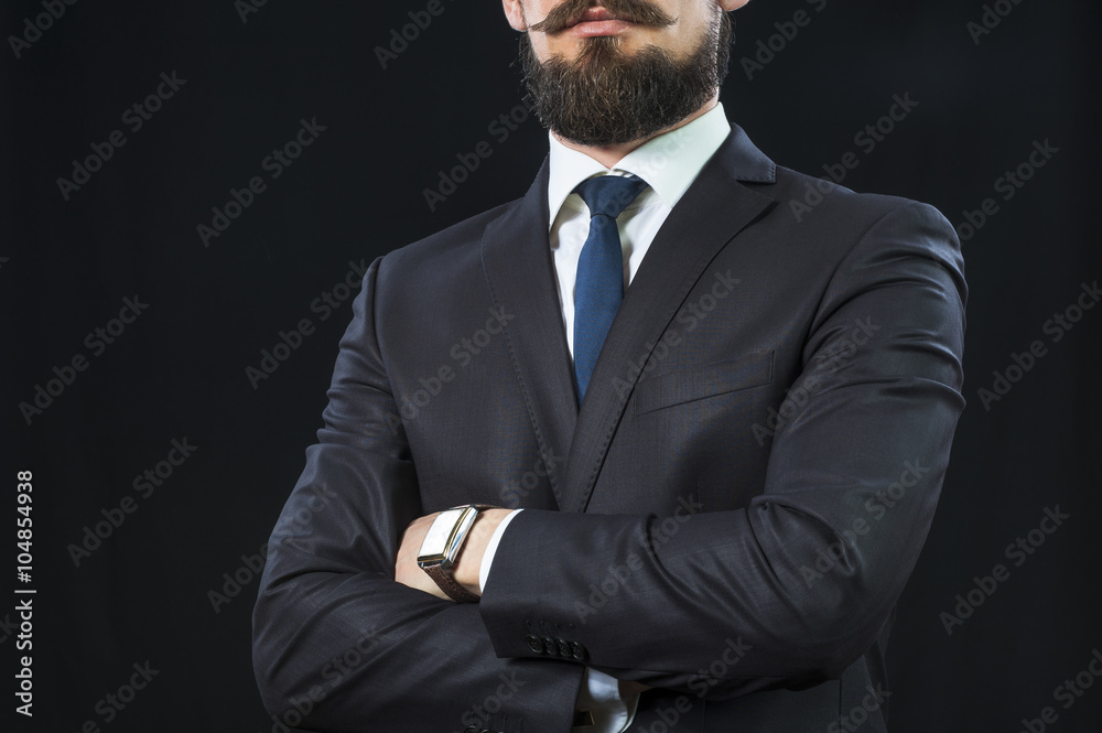 Bearded man in suit crossing his arms on chest Bearded man in suit crossing his arms on chest
