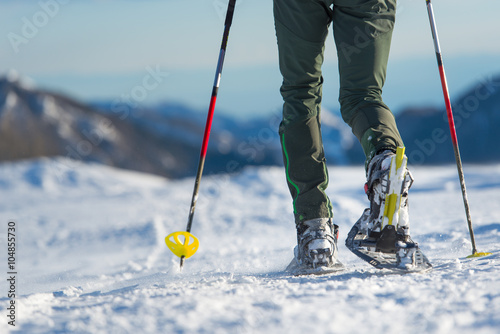 Foto Snowshoes. Snowshoeing closeup. Walking with snowshoes in the sn