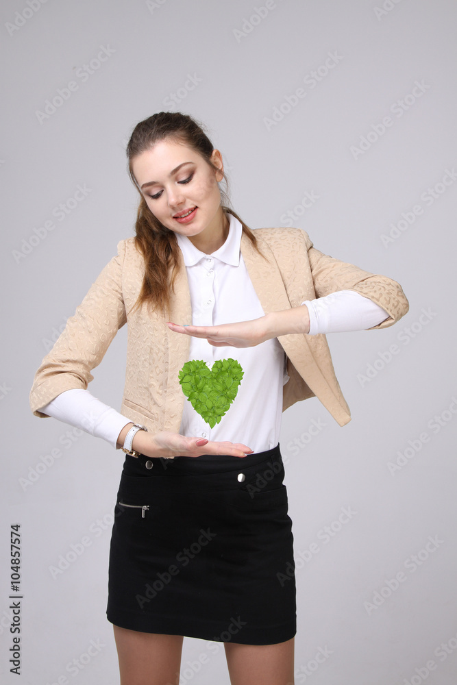 Woman holding green plant heart in her hands Woman holding green plant heart in her hands