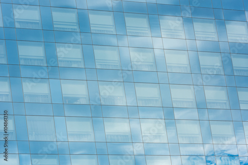 blue sky and clouds reflected in office building