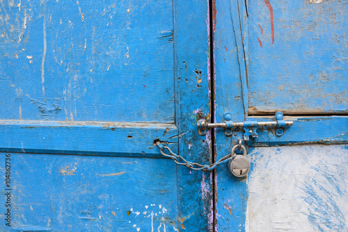 Old latch on a wooden blue door