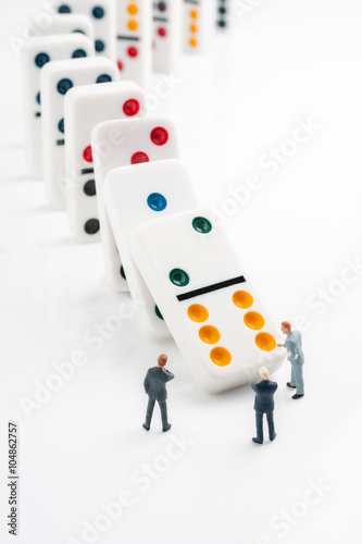 Domino effect concept of cascading errors or knock on effect of bad decisions