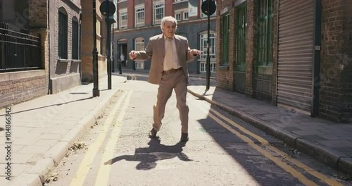 Contemporary funky elderly man street dancer dancing freestyle in the city