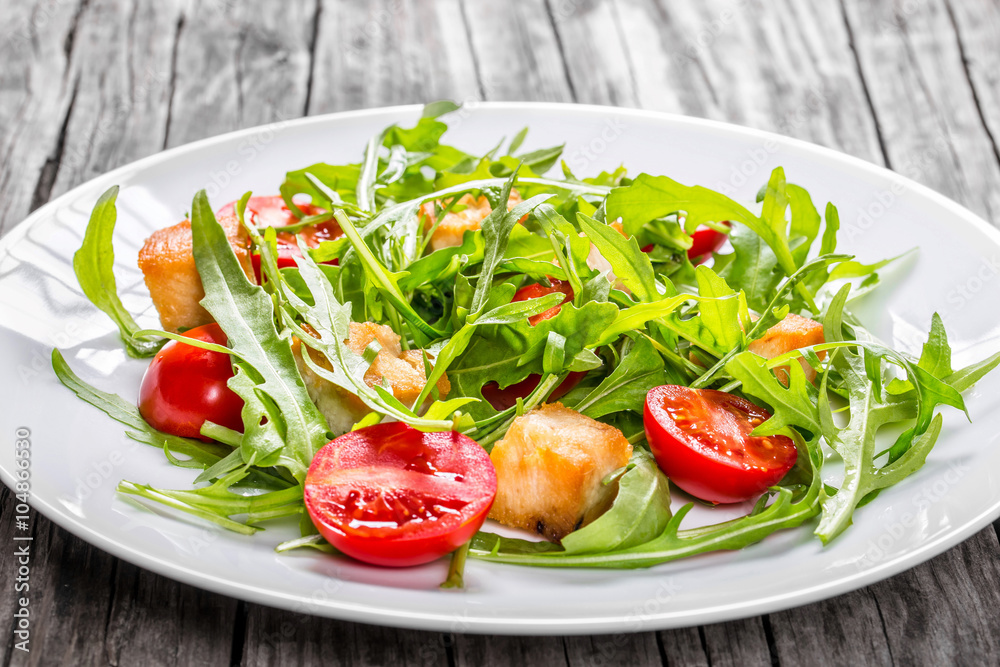 Fresh low-calories salad with chicken breast, arugula and tomato Fresh low-calories salad with chicken breast, arugula and tomato