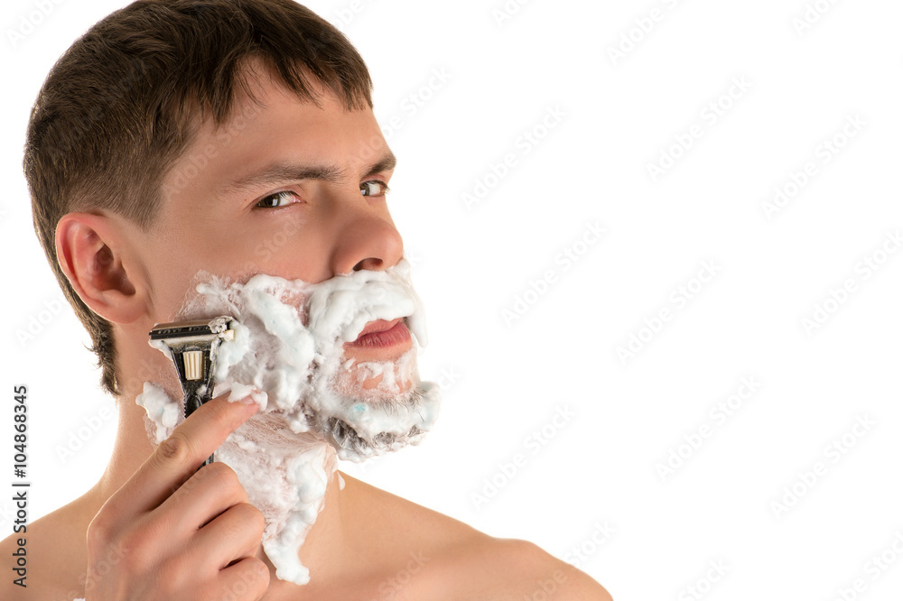 portrait of young caucasian male in shaving foam shaving razor sharp