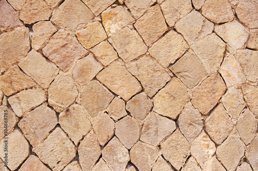 Fototapeta premium Old beige stone wall background texture