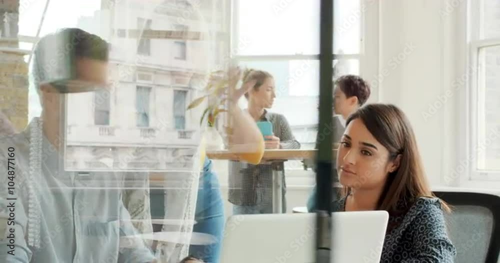 Creative business team meeting in modern start up office female team leader pointing at screen discussing diverse people group teamwork 