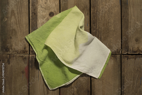 Gradient Green Towel on Wooden Panel Surface