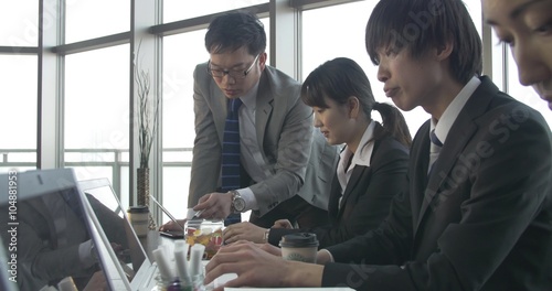 Busy Japanese work place with motivaeted atmosphere