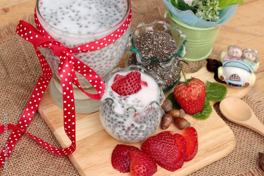 Chia seeds with milk and fresh strawberries.