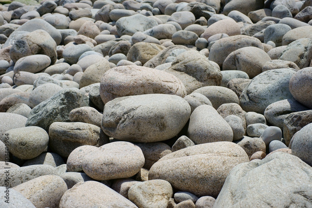 Grey sea pebbles in variety of sizes close up. Grey sea pebbles in variety of sizes close up.
